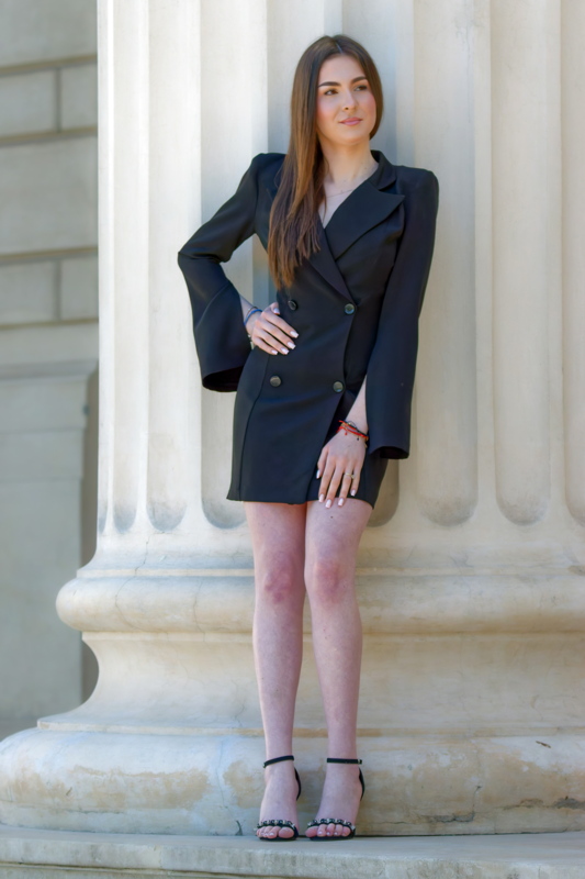 Girl posing near a building column